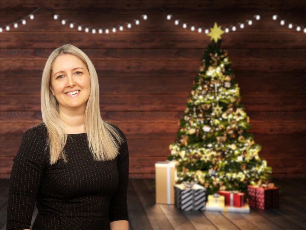 Lisa in front of Christmas tree