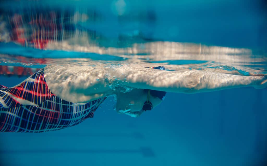 Female swimmer swimming in pool, underwater view