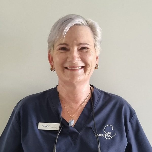 headshot of a nurse with a badge with Joanne on it