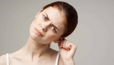 woman holding her ear health problems